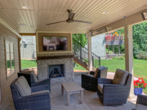 outside room under a deck with a TV